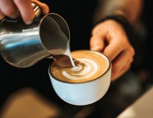 Barista prepares Latte art for coffee