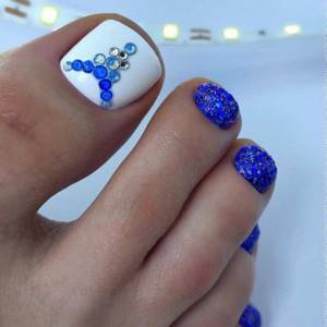 White and blue pedicure with rhinestones
