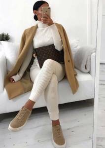 white knit suit with trousers and turtleneck, camel coat and sneakers for a neutral winter look