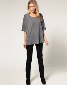 Black pants on a thin girl in a gray T-shirt