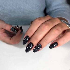 Black manicure with rhinestones and sparkles