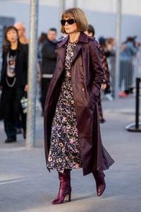 Girl in a floral midi dress, burgundy leather coat and high-heeled boots