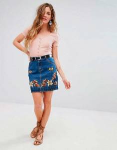 Girl in a denim skirt with embroidery