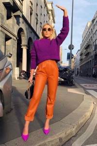 Girl in orange leather pants, purple sweater and stilettos
