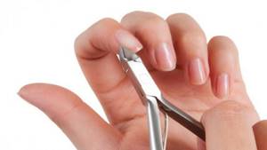 photo - cutting cuticles around the nail