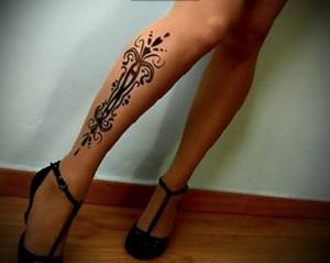 Elegant Indian style tattoo design on the calf