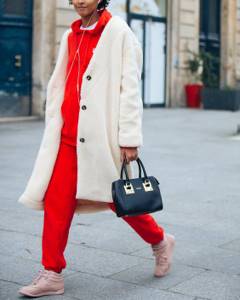 red tracksuit, beige sneakers and white fur coat