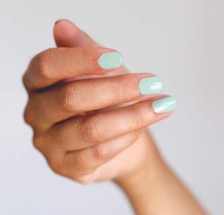 Manicure with a soft mint shade of varnish