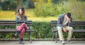 Guy and girl on different benches