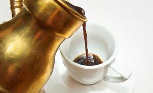pouring espresso into a cup