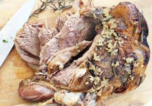 Serve leg of lamb with potatoes on the table