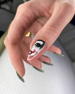 Joker design on ballerina shaped nail on thumb