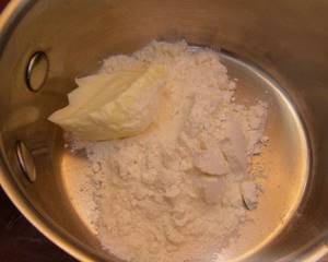 Combine butter and 100 g of sifted flour