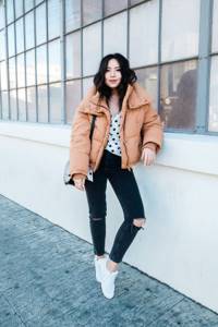 polka dot top, black ripped skinnies, brown soft jacket, white sneakers and black bag for winter