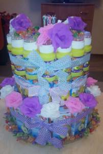 Cake for a girl with juices, barneys and soap bubbles.