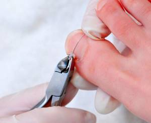 Installing a staple on a nail
