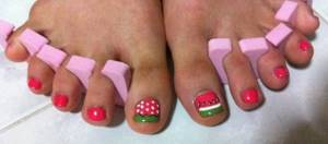 berry accents on a large nail in a pink pedicure